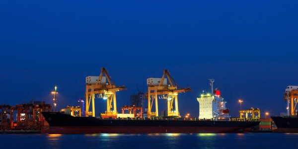 Container cargo freight ship at port twilight